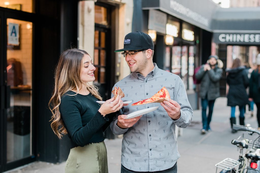couple poses with pizza for engagement session