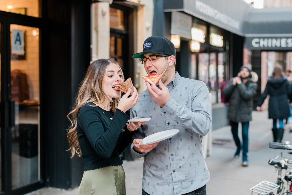couple enjoys pizza during nyc engagement