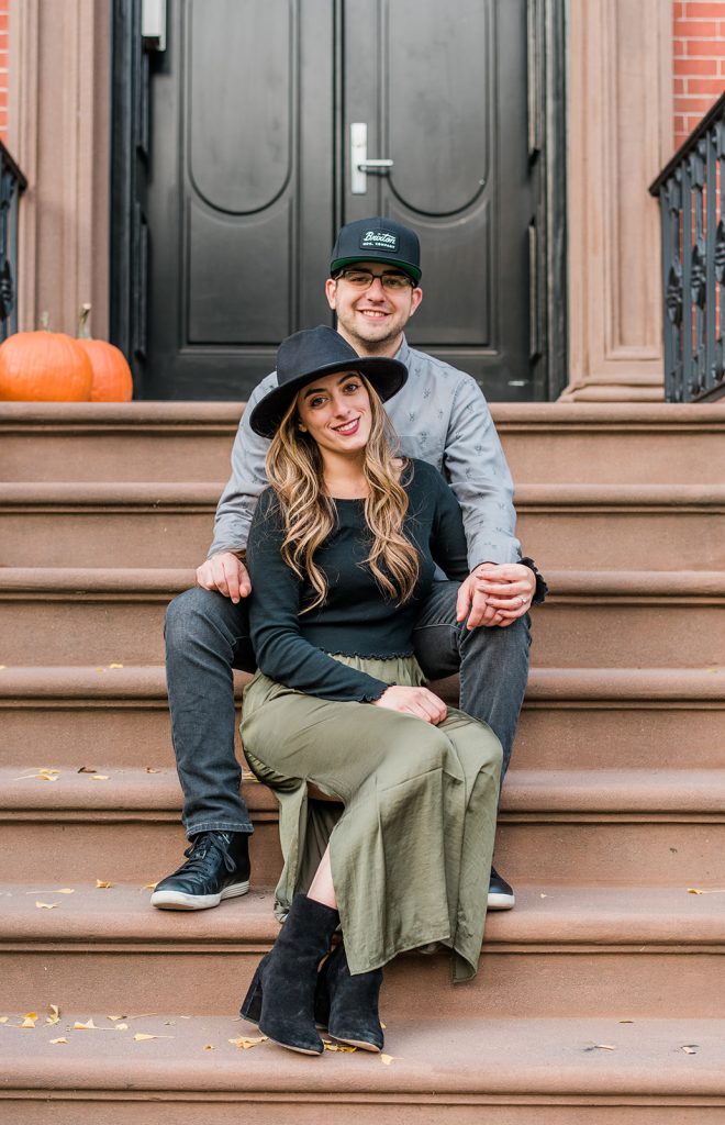 couple smiles for camera during nyc engagement session