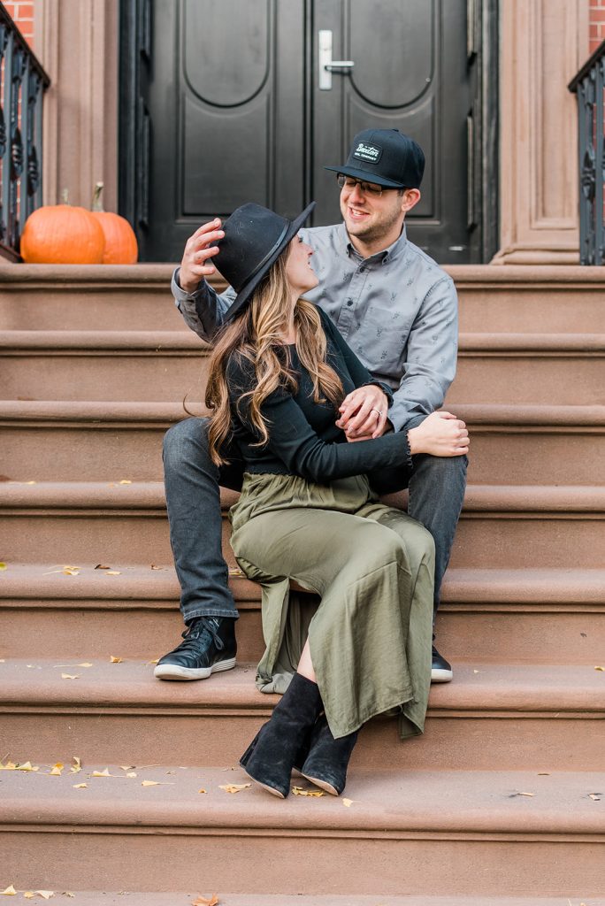 couple is playful during village engagement session
