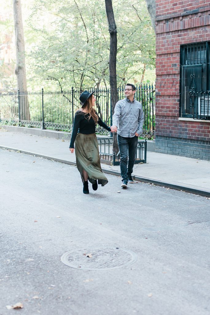 walking across the street in village during nyc engagement session
