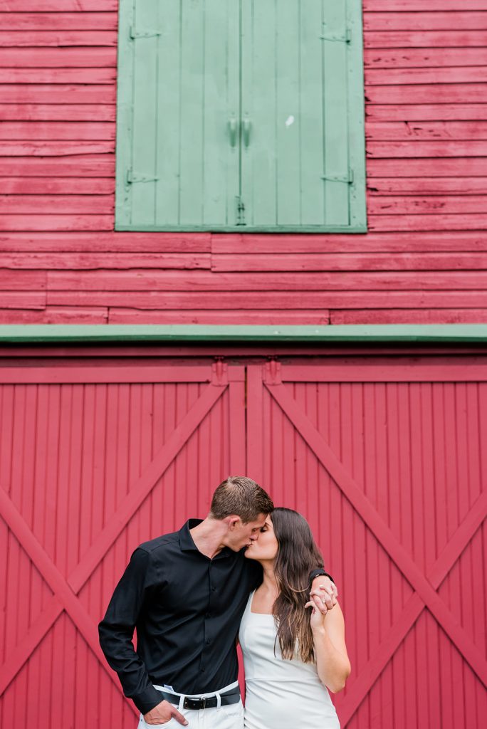 kiss during barn and farm engagement session