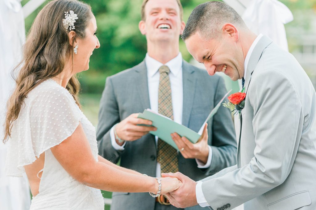 couple shares a laugh during intimate ceremony in hudson valley