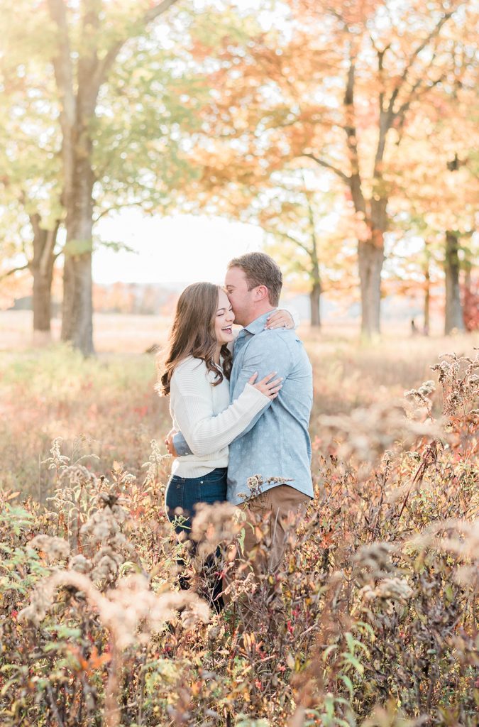 couple enjoys each other ni candid moment during their fall engagement session in the hudson valley