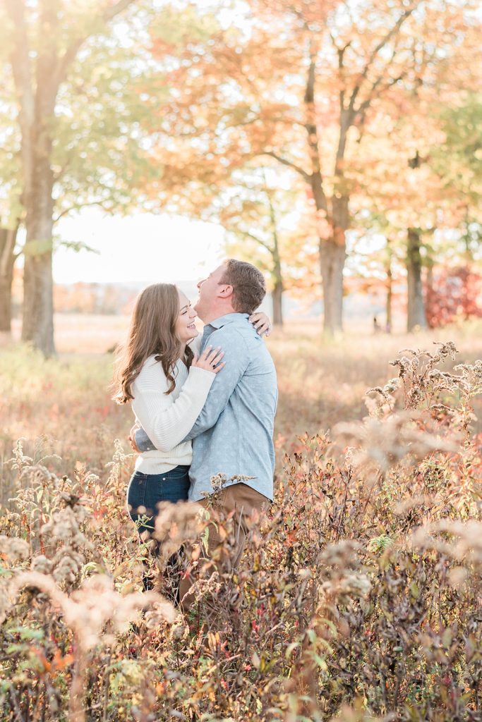 couple has a laugh during their fall engagement session in new paltz, ny