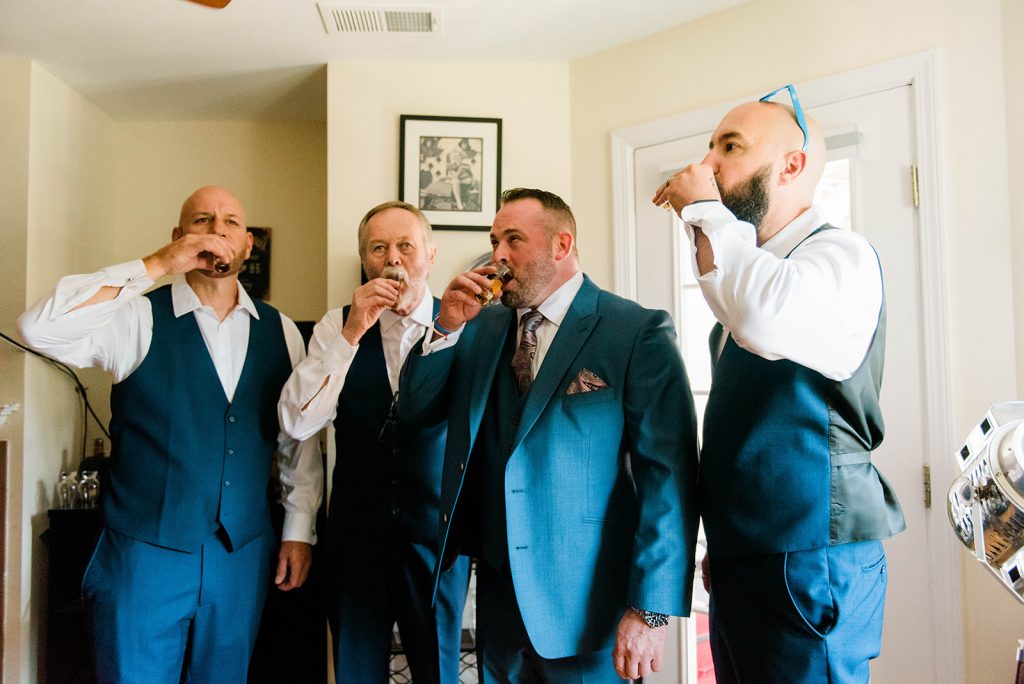 groom with groomsmen having a toast in westchester ny