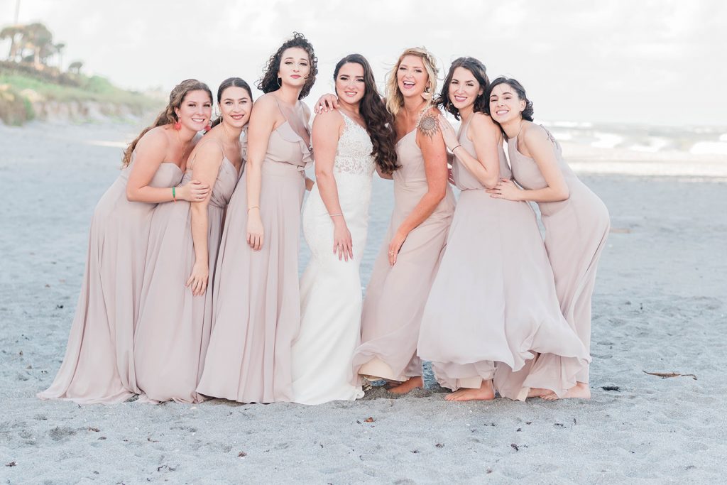 bride and bridesmaids share candid moment during portraits