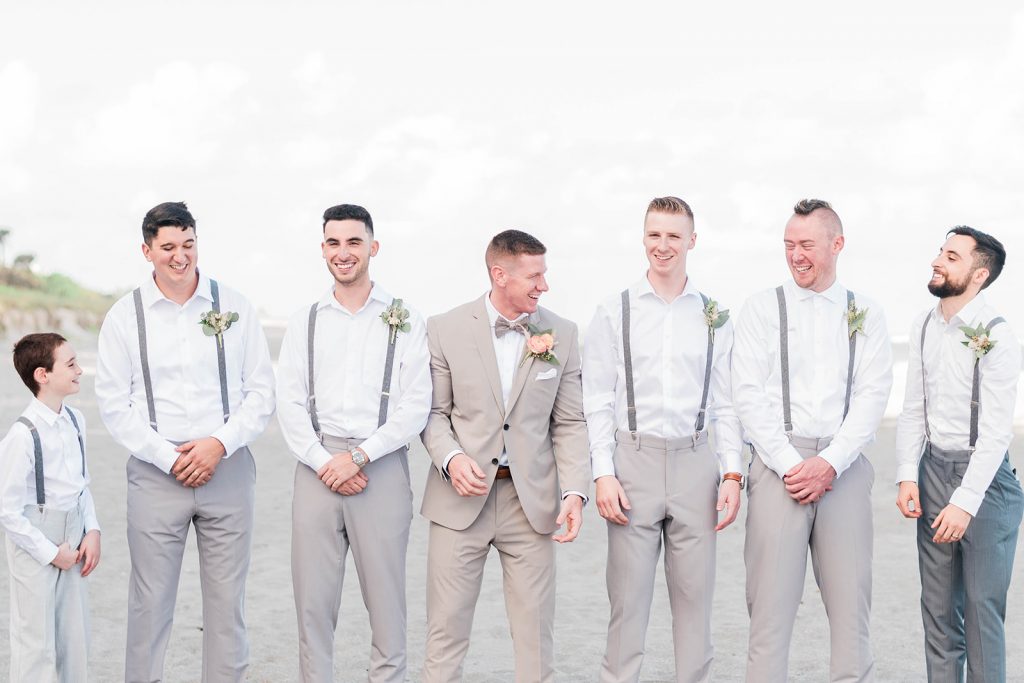 groom and groomsmen have candid moment during portraits