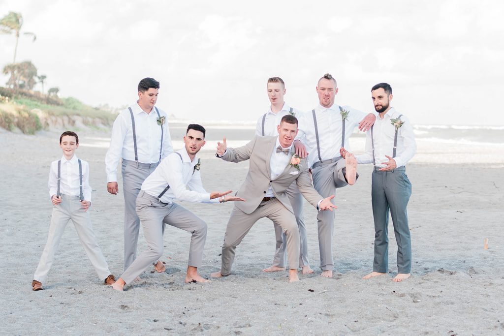 groom and groomsmen during portraits at beach wedding
