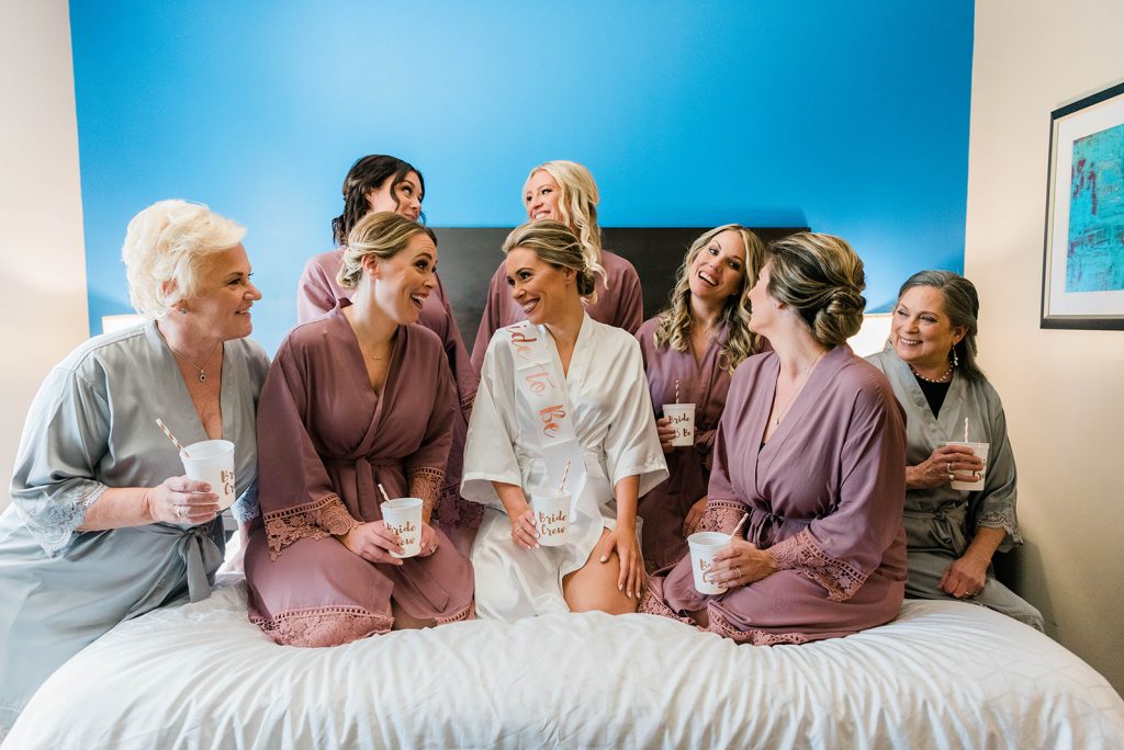 bride and bridesmaids have a toast before wedding
