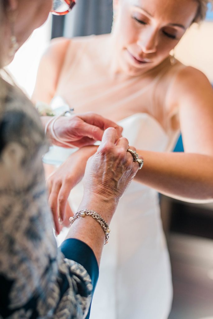 mom helps bride get ready for her wedding day