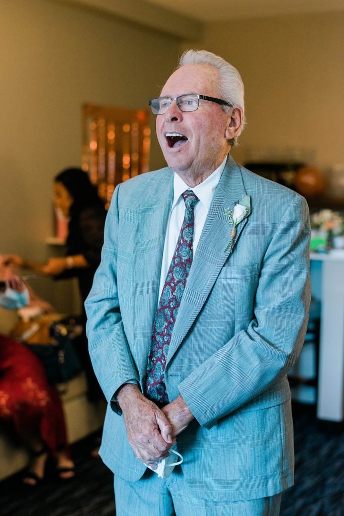 dad is surprised during first look with his daughter the bride