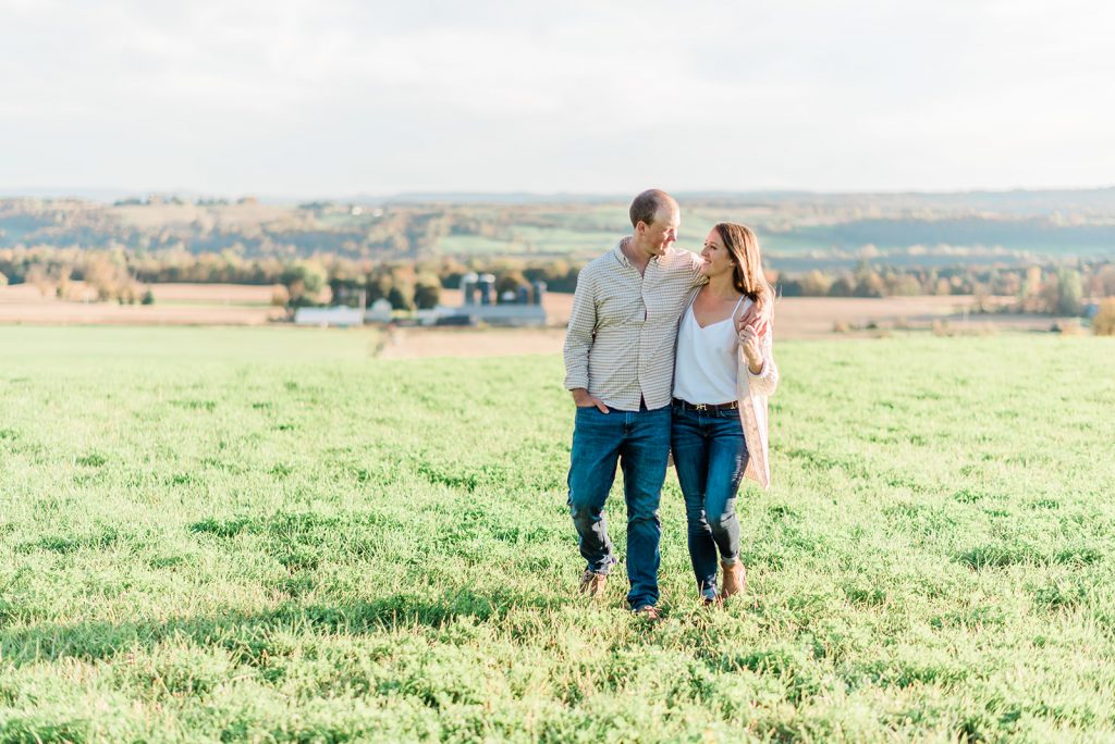 couple takes a romantic stroll during their farm engagement session
