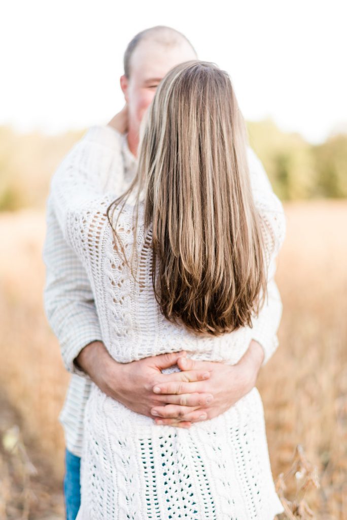 guy holds his girl during engagement shoot
