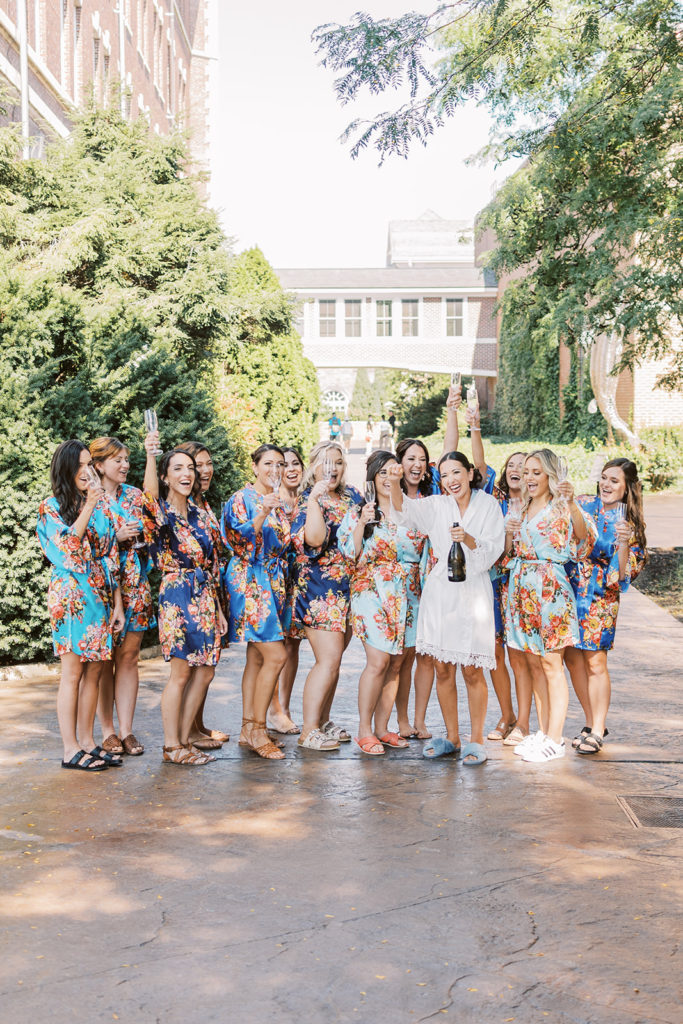 Brides shares toast with her bridesmaids at CIA wedding