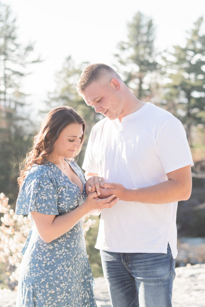 couple looks at ring after proposal at minnewaska
